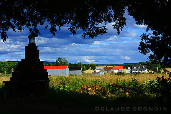 Colorful farm buildings highlighted by late afternoon warm light