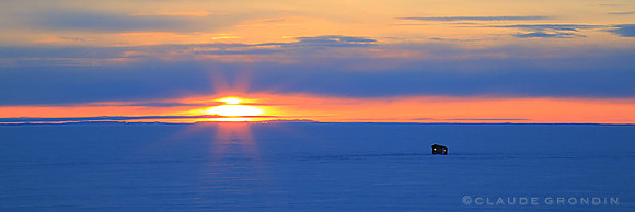 Rising sun above lac St-Jean and a little fishing cabin
